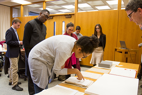 Playwrights Jackie Sibbles Drury (foreground), Kwame Kwei-Armah (center left), and Emily Mann (center) review historical sources. Photo Credit: Matt Pilsner