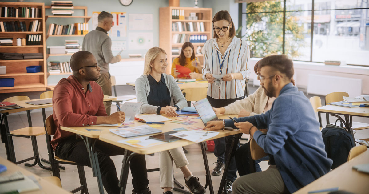 A group of adult learners with a teacher.