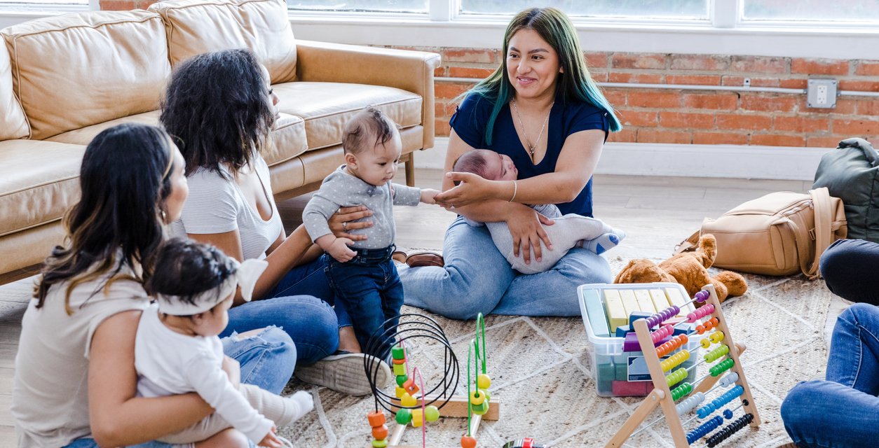 A group of smiling parents and their babies.