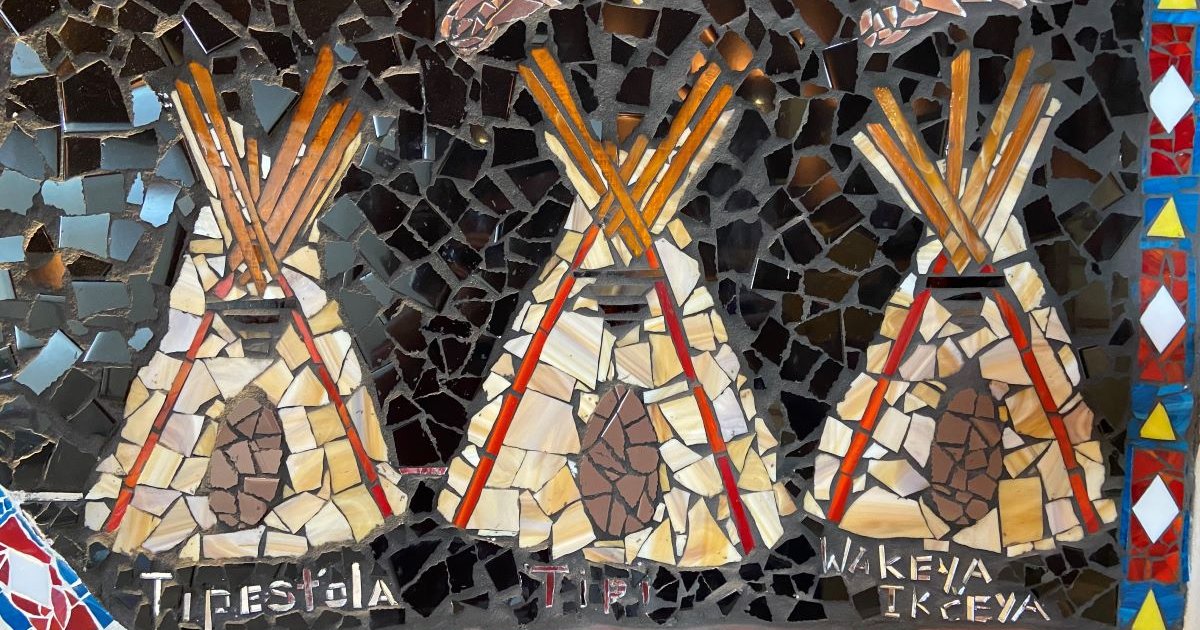 A tile mosaic of three tipis in Standing Rock.