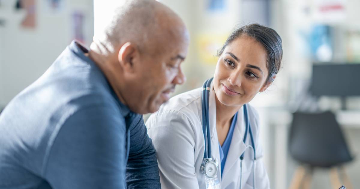 A health care provider discussing chronic disease care with a patient