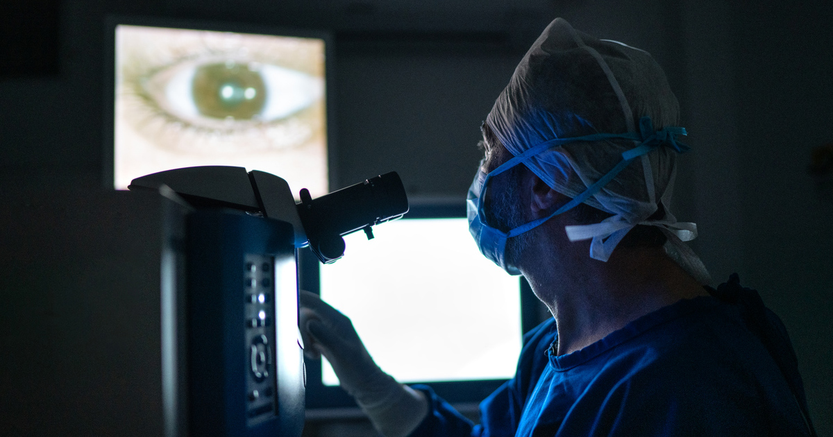 An ophthalmologist looking at a close-up image of an eye