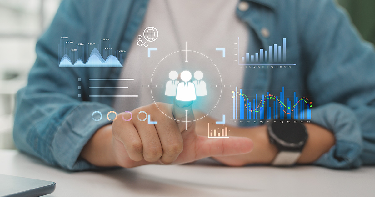 Person interacting with a digital dashboard displaying charts, graphs, and audience data representing predictive analytics.