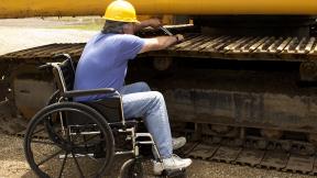 worker wearing hard hat in wheelchair