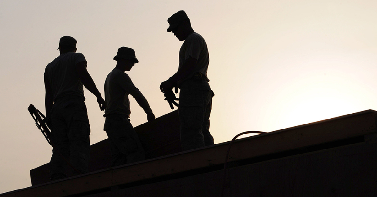 Construction workers in silhouette