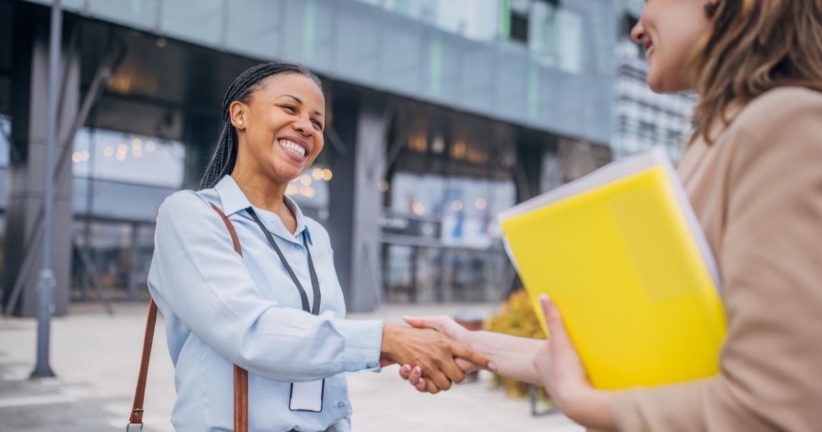 Smiling women shaking hands