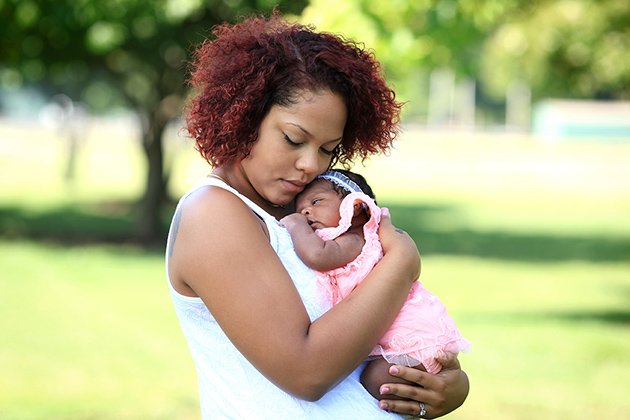 teen mom holding infant