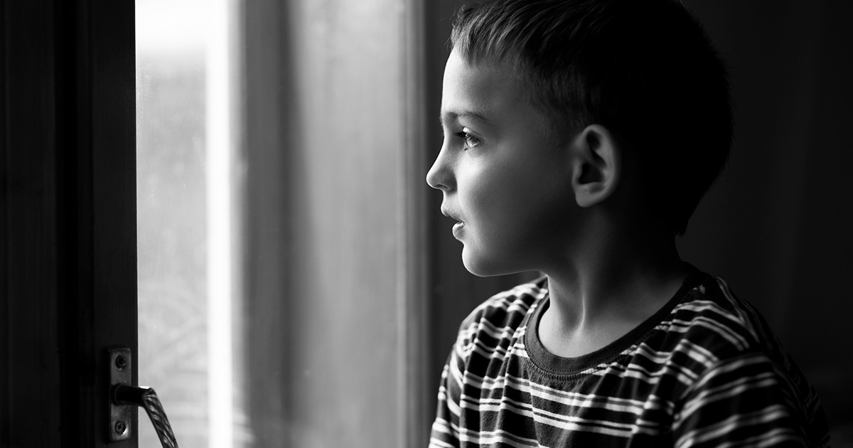A child looking out a window. 