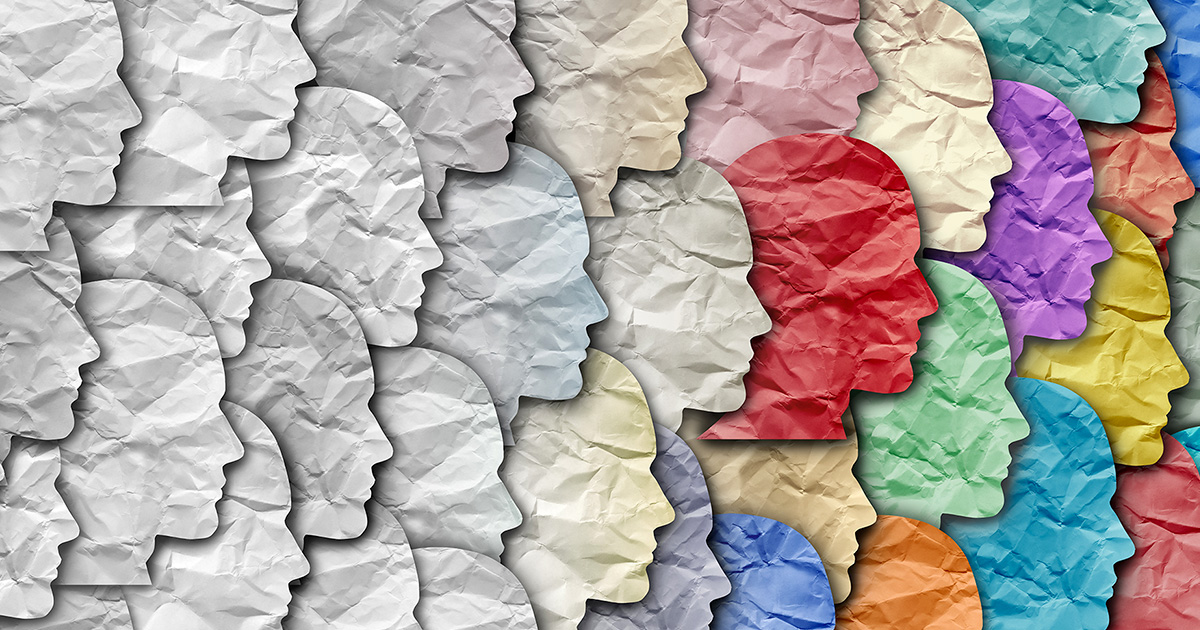 Right-facing profiles of faces cut from crinkled paper, overlaying each other, fading from white on the left to many different colors on the right. 
