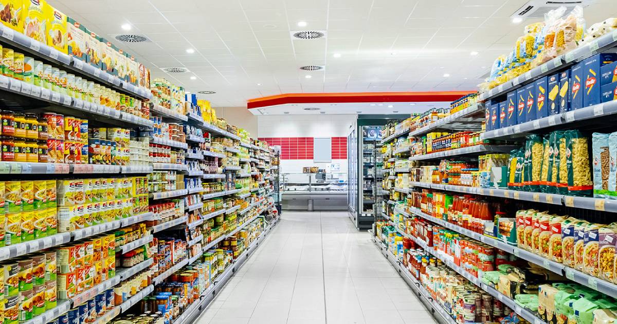 Grocery shelves in a supermarket filled with canned and dried goods
