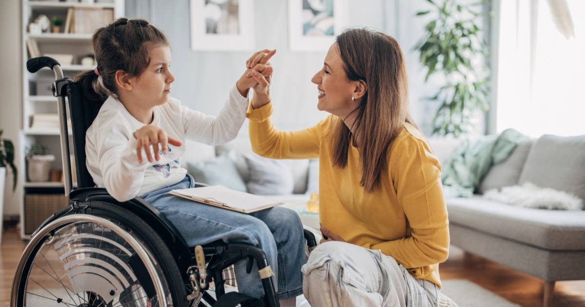 Young girl in wheel chair getting care from a specialist at home