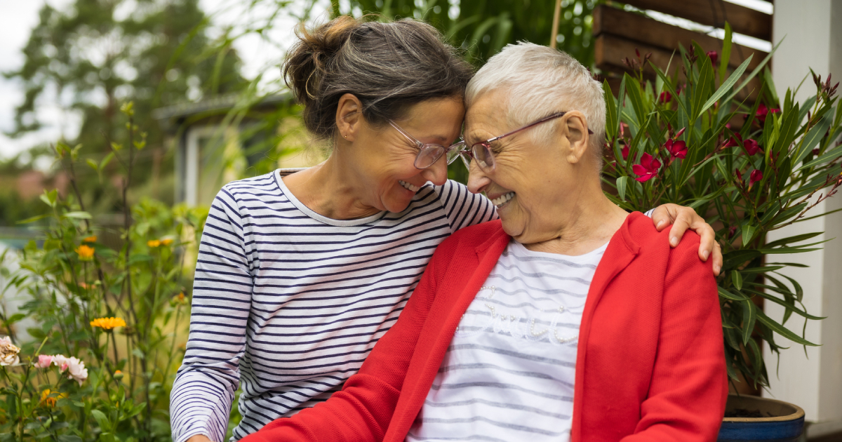 A smiling senior woman with her caregiver