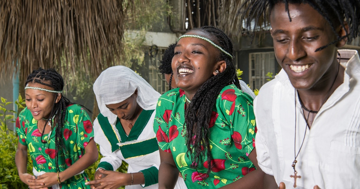 From left to right: Shewit, Endegena, Kidest, and Mastawal wear traditional attire during a dancing performance at the Family Guidance Association of Ethiopia (FGAE) edutainment center. FGAE offers sexual and reproductive health (SRH) services across the country, including in five zones of the Oromia Region. It has a network of 46 comprehensive SRH service delivery clinics and employs a youth-centered approach, which involves implementing services where adolescents and young people can easily access them, rather than directing clients to particular facilities. 