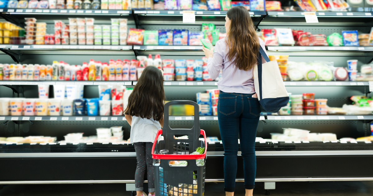 A parent and child shopping in a grocery store