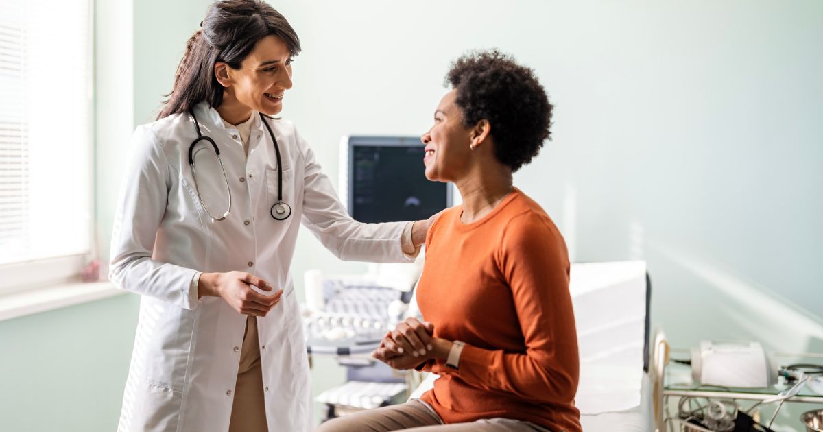 Female medical practitioner reassuring a patient