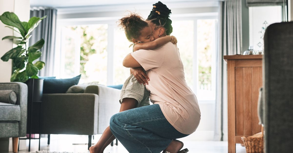 Shot of a mother and child hugging at home