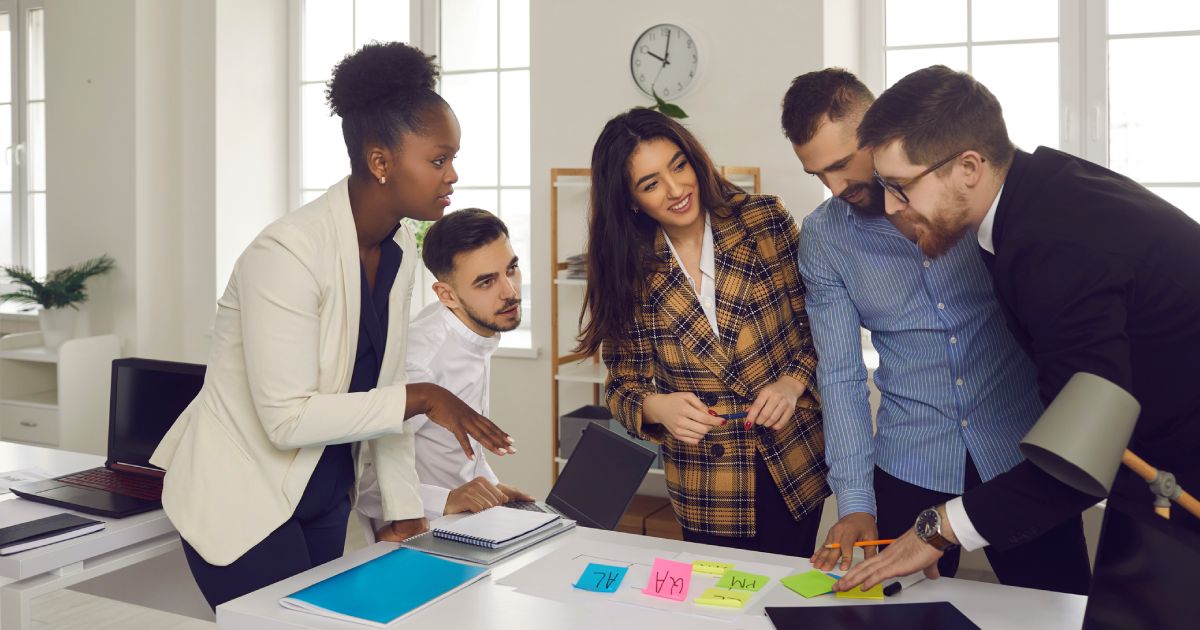 multiethnic business team with marker pen and stickers working in office