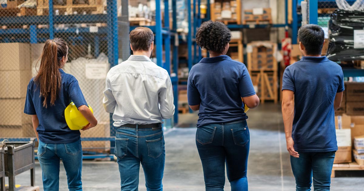  Warehouse workers walking in plant.