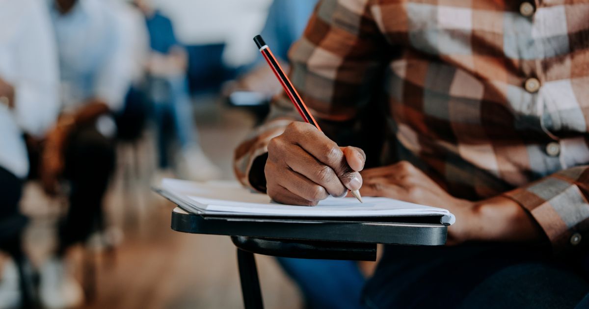 a person writing in the classroom