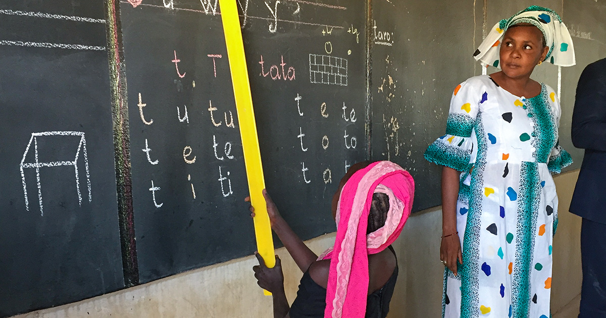 a teacher and child in classroom