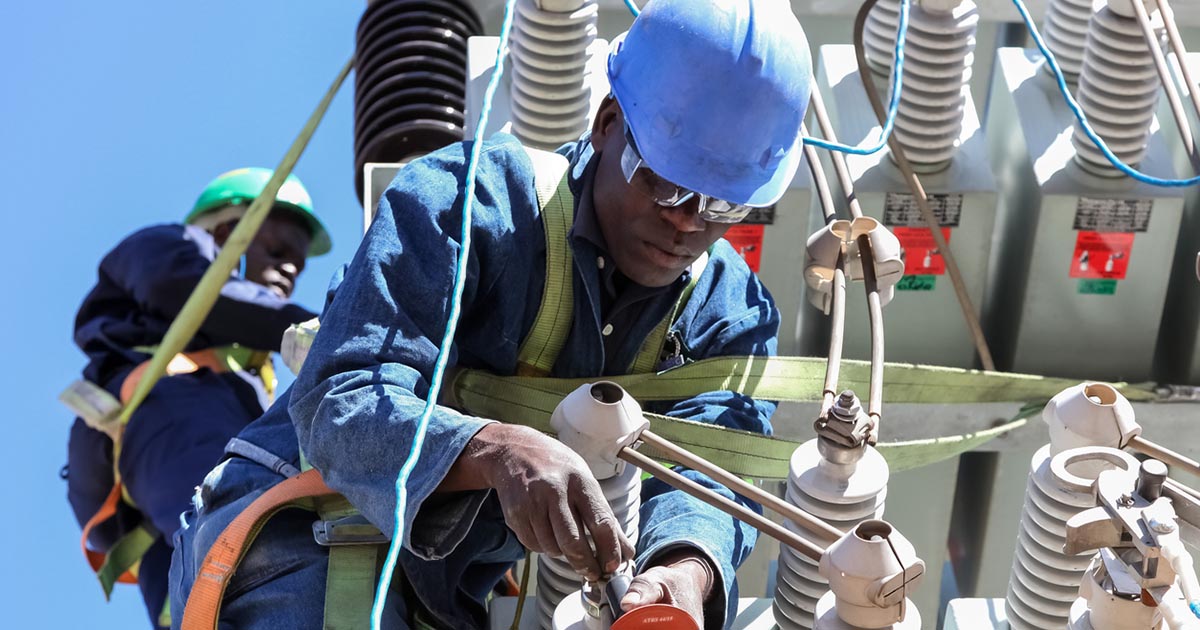 Johannesburg, South Africa, 04/11/2012, Electricians working on high voltage power lines. Highly skilled workmen servicing the electricity grid