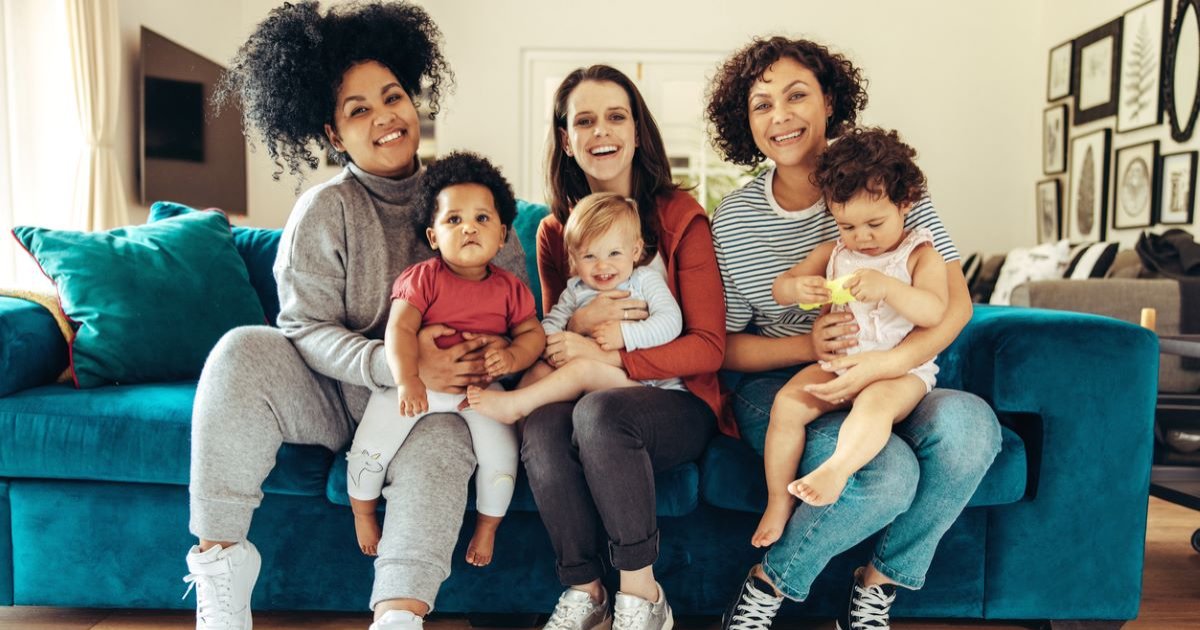 A smiling group of mothers with their babies